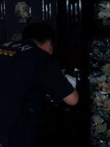 This photo is after the second robbery experience Ian and I had, in our apartment in Seoul. The photo is of a Korean police officer dusting our wardrobe for finger prints. 